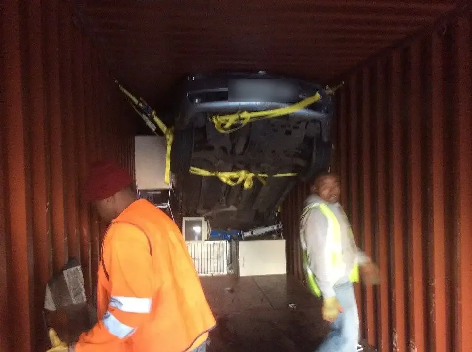 Rolats team securing a vehicle inside a container as freight forwarders to Africa
